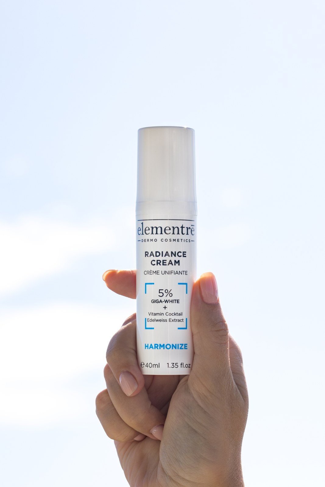 elementrē 5% Giga-White Radiance Face Cream held in hand